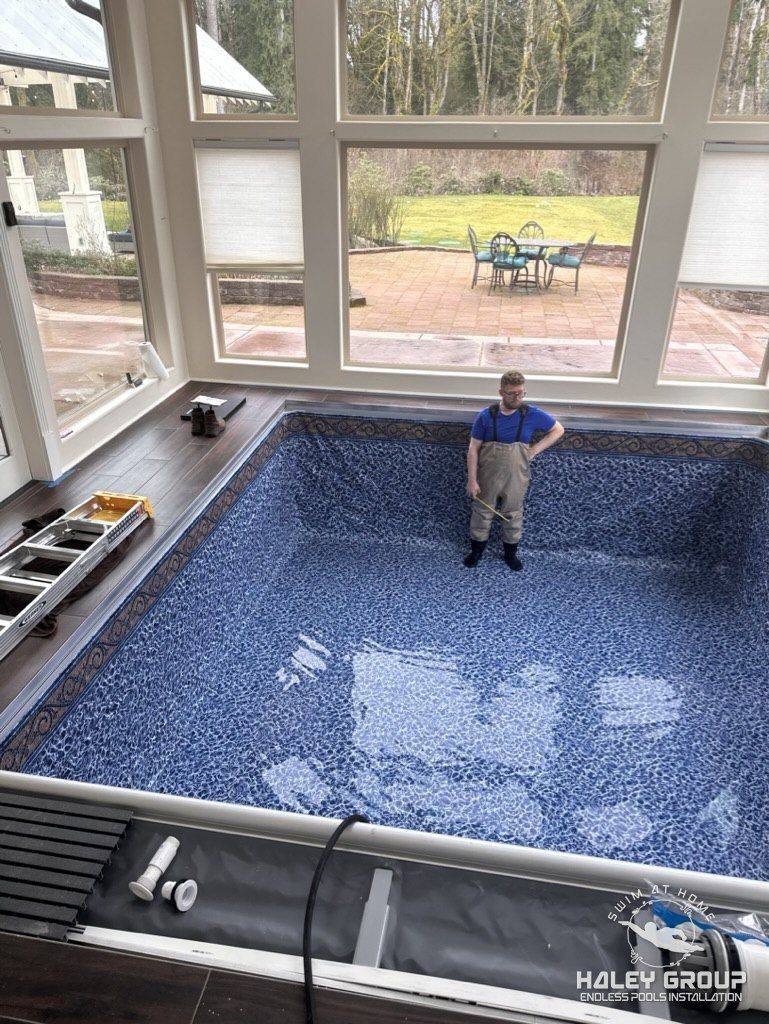 Installer in waders checking the new mosaic-pattern liner