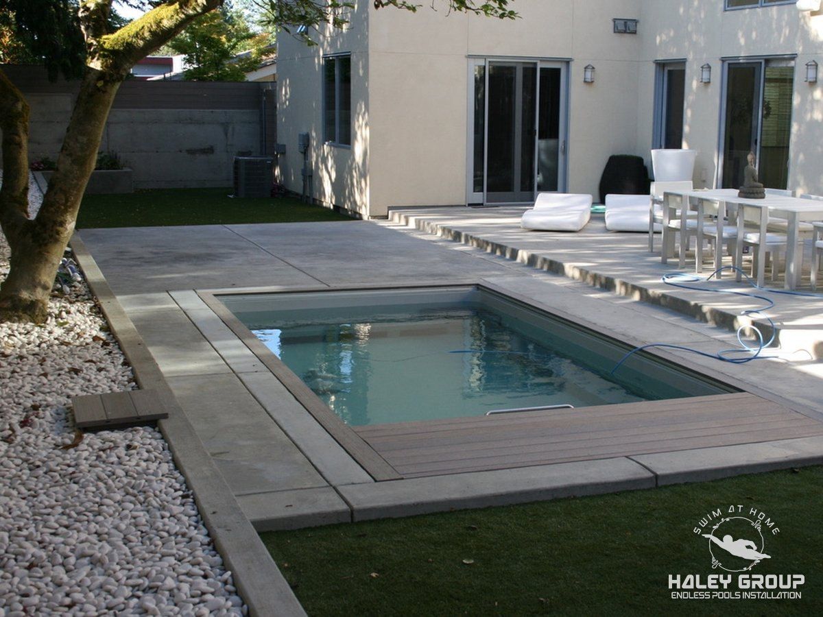 Finished in-ground Endless Pool with flush decking and concrete coping