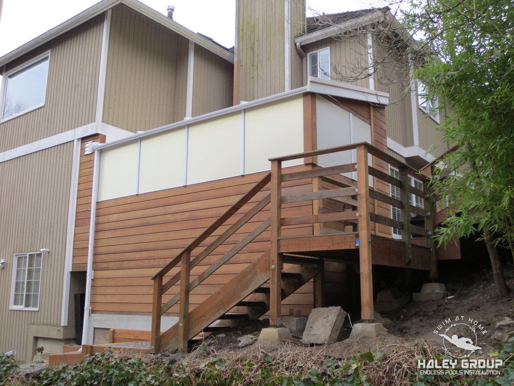 Exterior: IPE (ironwood) clad pool enclosure with translucent upper panels and new stairs