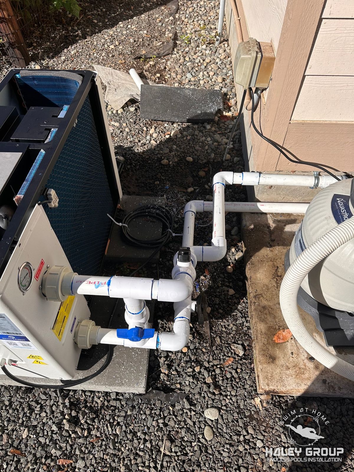 Installed heat pump plumbed into the pool filter with PVC piping, bypass valve and isolation valves