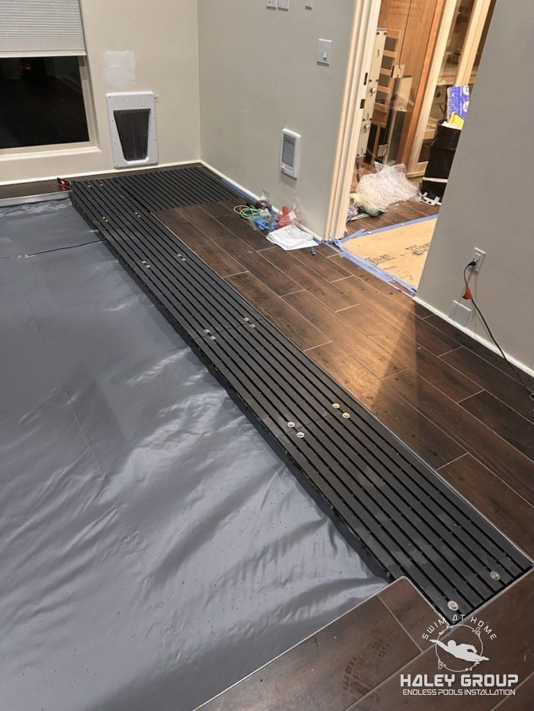 Custom removable grate floor sections over the pool equipment, set flush with the tile