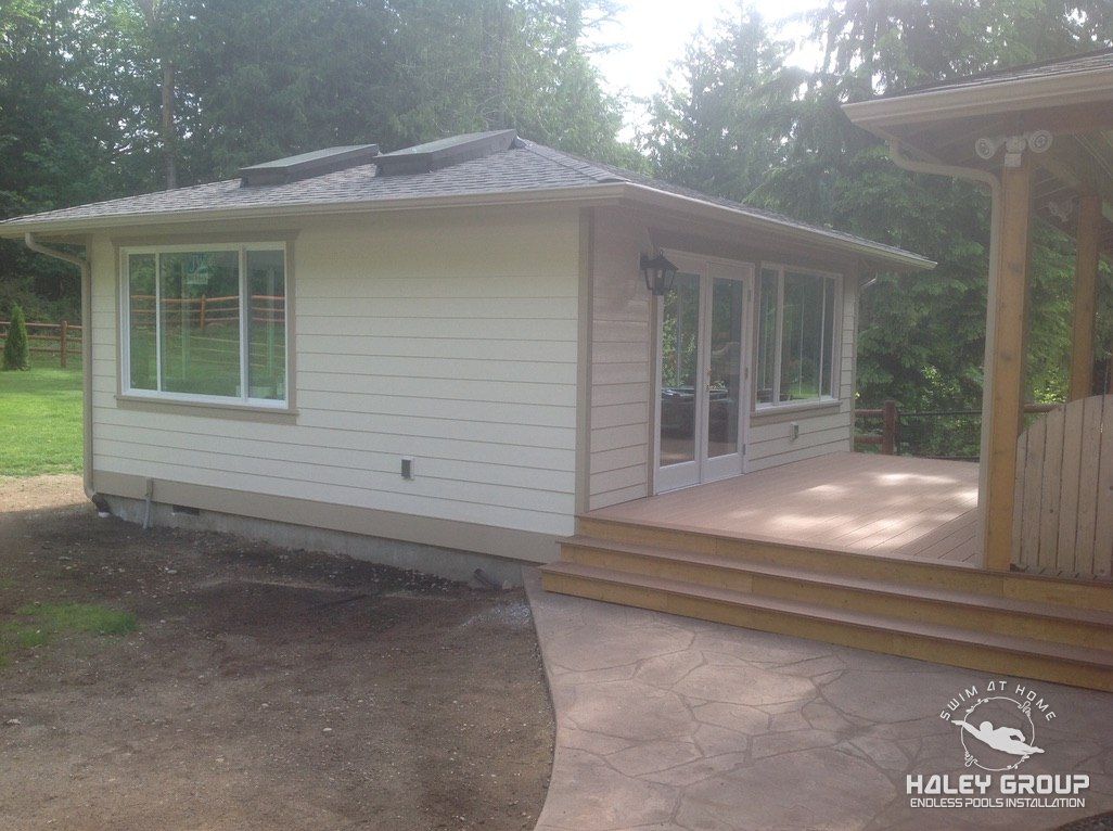 Sunroom addition with new deck, steps and stamped patio