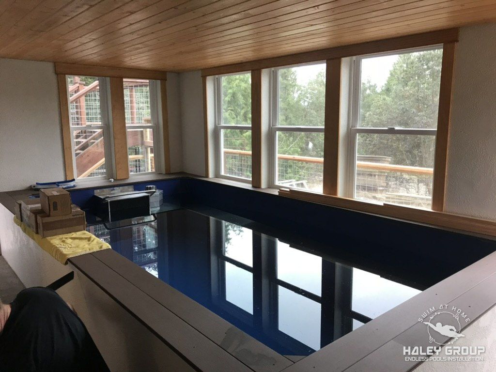 The same room finished, with the pool filled beneath a bank of windows