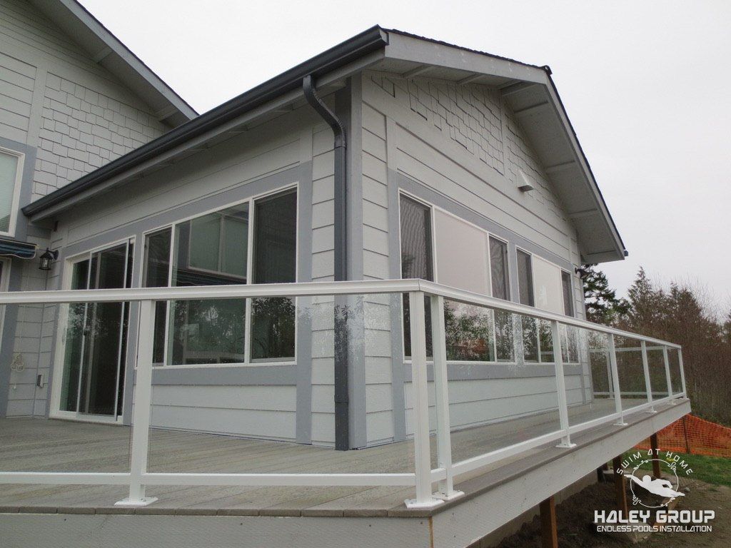 Sunroom gable end and glass-panel deck railing